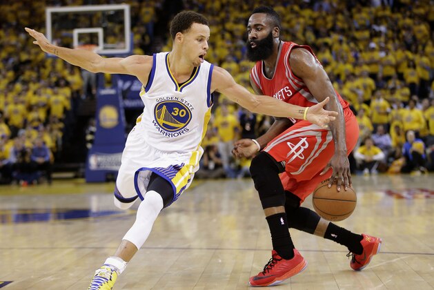 Houston Rockets guard James Harden, right, dribbles against Golden State Warriors guard Stephen Curry (30) during the first half of Game 2 of the NBA basketball Western Conference finals in Oakland, Calif., Thursday, May 21, 2015. (AP Photo/Rick Bowmer)