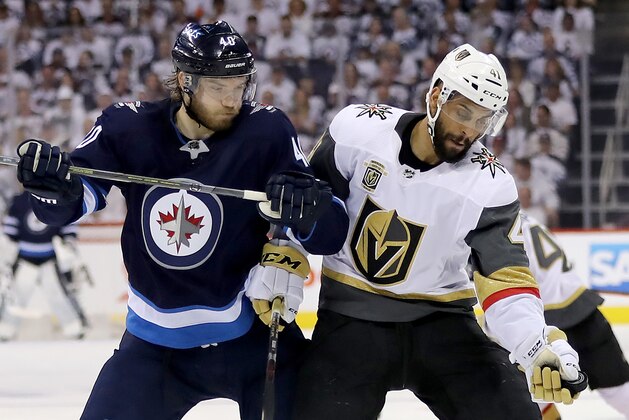 WINNIPEG, MB - MAY 12:  Pierre-Edouard Bellemare #41 of the Vegas Golden Knights grabs the puck as Joel Armia #40 of the Winnipeg Jets defends in Game One of the Western Conference Finals during the 2018 NHL Stanley Cup Playoffs at Bell MTS Place on May 12, 2018 in Winnipeg, Canada.  (Photo by Elsa/Getty Images)