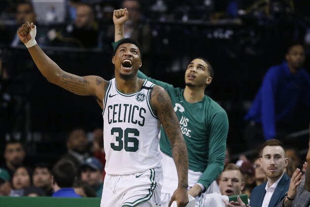 Boston Celtics guard Marcus Smart (36) and forward Jayson Tatum cheer from the bench along with injured Gordon Haywood who watches in street clothes, far right, during the fourth quarter of Game 1 of the NBA basketball Eastern Conference Finals against the Cleveland Cavaliers, Sunday, May 13, 2018, in Boston. The Celtics won 108-83. (AP Photo/Michael Dwyer)