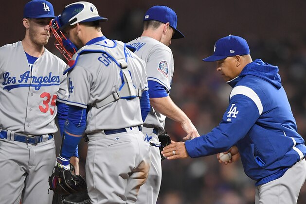 SAN FRANCISCO, CA - APRIL 28:  Manager Dave Roberts #30 of the Los Angeles Dodgers takes the ball from pitcher Daniel Hudson #41 taking Hudson out of the game against the San Francisco Giants in the bottom of the seventh inning of game two of a double header at AT&T Park on April 28, 2018 in San Francisco, California.  (Photo by Thearon W. Henderson/Getty Images)