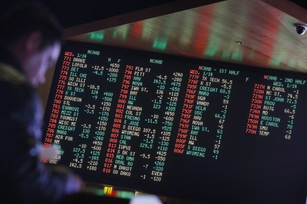 FILE - In this Jan. 14, 2015, file photo, odds are displayed on a screen at a sports book owned and operated by CG Technology in Las Vegas. More than a third of U.S. states are considering legalizing sports gambling if the Supreme Court overturns a federal law that has banned sports books in all but Nevada and three other states since 1992. (AP Photo/John Locher, File)