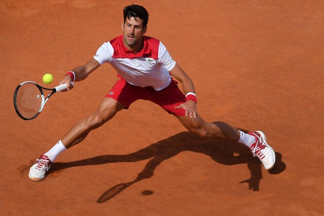 Serbia's Novak Djokovic returns the ball to Alexandr Dolgopolov of Ukraine during the ATP Tennis Open tournament on May 14, 2018 at the Foro Italico in Rome. (Photo by TIZIANA FABI / AFP)        (Photo credit should read TIZIANA FABI/AFP/Getty Images)