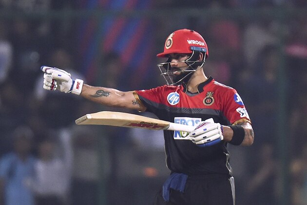 Royal Challengers Bangalore captain Virat Kohli celebrates his half century (50 runs) during the 2018 Indian Premier League (IPL) Twenty20 cricket match between Delhi Daredevils and Royal Challengers Bangalore at the Feroz Shah Kotla Cricket Stadium in New Delhi on May 12, 2018. (Photo by CHANDAN KHANNA / AFP)        (Photo credit should read CHANDAN KHANNA/AFP/Getty Images)