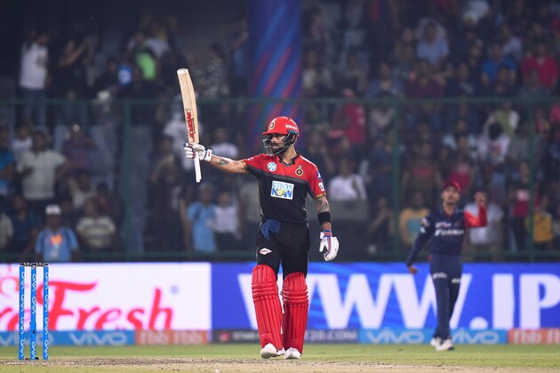 Royal Challengers Bangalore captain Virat Kohli celebrates his half century (50 runs) during the 2018 Indian Premier League (IPL) Twenty20 cricket match between Delhi Daredevils and Royal Challengers Bangalore at the Feroz Shah Kotla Cricket Stadium in New Delhi on May 12, 2018. (Photo by CHANDAN KHANNA / AFP)        (Photo credit should read CHANDAN KHANNA/AFP/Getty Images)