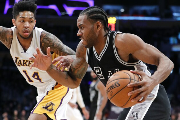 San Antonio Spurs' Kawhi Leonard, right, drives past Los Angeles Lakers' Brandon Ingram during the second half of an NBA basketball game, Sunday, Feb. 26, 2017, in Los Angeles. (AP Photo/Jae C. Hong)