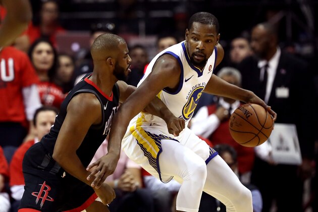HOUSTON, TX - MAY 14: Kevin Durant #35 of the Golden State Warriors handles the ball against Chris Paul #3 of the Houston Rockets in the first quarter  in Game One of the Western Conference Finals of the 2018 NBA Playoffs at Toyota Center on May 14, 2018 in Houston, Texas. NOTE TO USER: User expressly acknowledges and agrees that, by downloading and or using this photograph, User is consenting to the terms and conditions of the Getty Images License Agreement.  (Photo by Ronald Martinez/Getty Images)