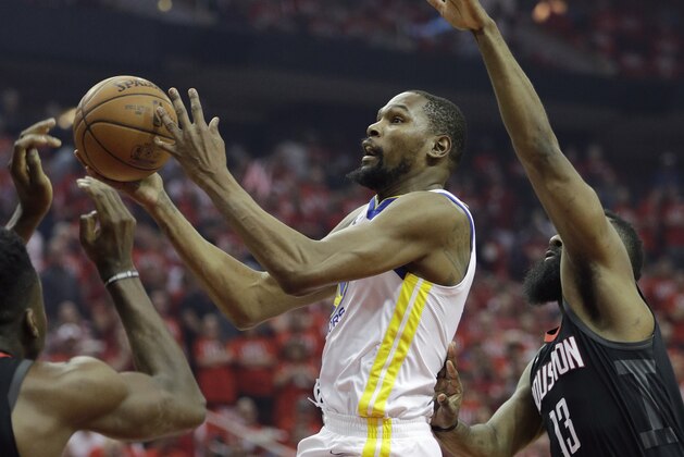 Golden State Warriors forward Kevin Durant (35) drives to the basket past Houston Rockets guard James Harden (13) during the first half of Game 1 of the NBA basketball Western Conference Finals, Monday, May 14, 2018, in Houston. (AP Photo/David J. Phillip)