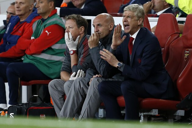 Arsenal's French manager Arsene Wenger (R), Arsenal's assistant manager Steve Bould (C) and irst-team physiotherapist Colin Lewin (L) react during the English Premier League football match between Arsenal and Leicester City at the Emirates Stadium in London on August 11, 2017. / AFP PHOTO / Ian KINGTON / RESTRICTED TO EDITORIAL USE. No use with unauthorized audio, video, data, fixture lists, club/league logos or 'live' services. Online in-match use limited to 75 images, no video emulation. No use in betting, games or single club/league/player publications.  /         (Photo credit should read IAN KINGTON/AFP/Getty Images)