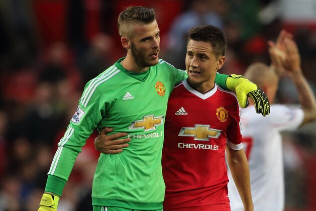 MANCHESTER, ENGLAND - SEPTEMBER 12:  David De Gea of Manchester United walks off with Ander Herrera of Manchester United after the 3-1 victory in the Barclays Premier League match between Manchester United and Liverpool on September 12, 2015 in Manchester, United Kingdom.  (Photo by Matthew Ashton - AMA/Getty Images)