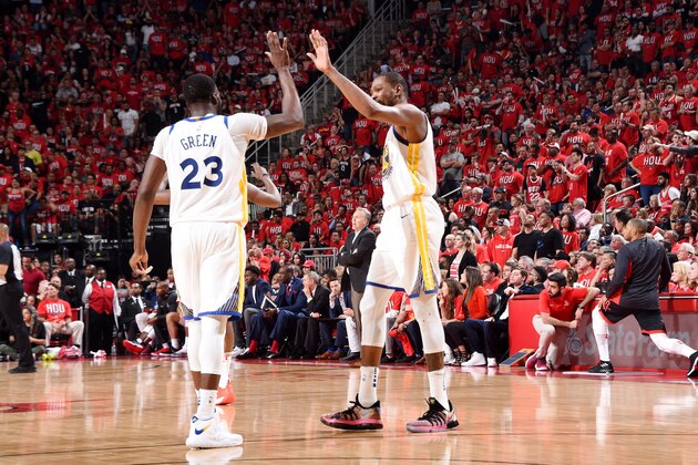 HOUSTON, TX - MAY 14:  Draymond Green #23 and Kevin Durant #35 of the Golden State Warriors exchange a high five during Game One of the Western Conference Finals of the 2018 NBA Playoffs on May 14, 2018 at the Toyota Center in Houston, Texas. NOTE TO USER: User expressly acknowledges and agrees that, by downloading and or using this photograph, User is consenting to the terms and conditions of the Getty Images License Agreement. Mandatory Copyright Notice: Copyright 2018 NBAE (Photo by Andrew D. Bernstein/NBAE via Getty Images)
