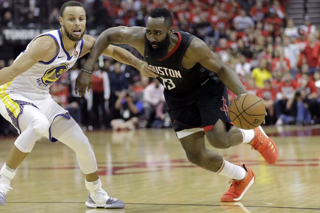 Houston Rockets guard James Harden (13) drives around Golden State Warriors guard Stephen Curry (30) during the second half of Game 1 of the NBA basketball Western Conference Finals, Monday, May 14, 2018, in Houston. (AP Photo/David J. Phillip)