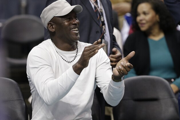 Charlotte Hornets owner Michael Jordan applauds his team against the Orlando Magic in the second half of an NBA basketball game in Charlotte, N.C., Friday, March 10, 2017. The Hornets won 121-81. (AP Photo/Chuck Burton)