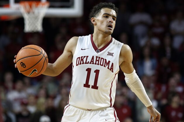 FILE - In this Feb. 17, 2018, file photo, Oklahoma guard Trae Young (11) brings the ball upcourt during the second half of an NCAA college basketball game against Texas in Norman, Okla. Young leads the country in both scoring and assists entering the final weekend of the regular season.  (AP Photo/Sue Ogrocki, File)