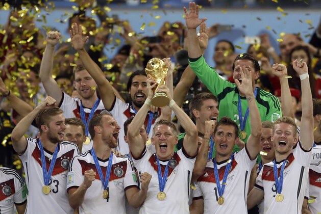 FILE - In this July 13, 2014 file photo Germany's Bastian Schweinsteiger holds up the World Cup trophy as the team celebrates their 1-0 victor over Argentina after the World Cup final soccer match between Germany and Argentina at the Maracana Stadium in Rio de Janeiro, Brazil. Germany captain Bastian Schweinsteiger said Friday, July 29, 2016 he is quitting the national team. The 31-year-old said in a Twitter statement that he’s asked Germany coach not to include him in the line-up in future.  (AP Photo/Natacha Pisarenko, file)