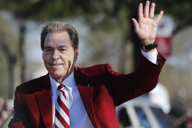 Alabama's coach Nick Saban waves to fans as he parades down the street during the NCAA college football national championship parade, Saturday, Jan. 20, 2018, in Tuscaloosa, Ala. Alabama won the national championship game against Georgia 26-23 in overtime. (AP Photo/Brynn Anderson)