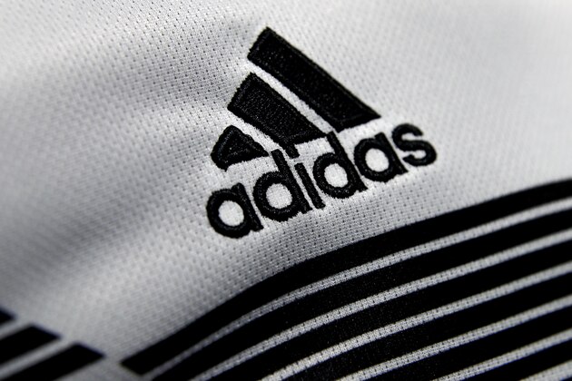 The logo of German sports equipment company adidas AG is printed on a shirt during the annual balance news conference in Herzogenaurach, Germany, Wednesday, March 14, 2018. (AP Photo/Matthias Schrader)