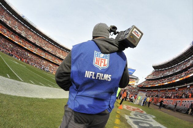 An NFL Films camera man works on the sideline of an NFL football game between the Cleveland Browns and the Indianapolis Colts Sunday, Dec. 7, 2014, in Cleveland. The Colts won 25-24. (AP Photo/David Richard)