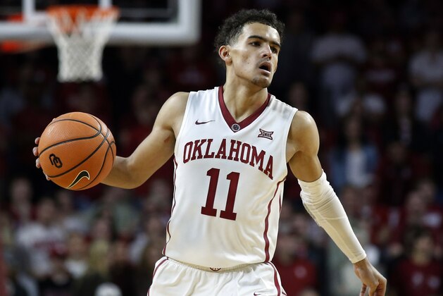 FILE - In this Feb. 17, 2018, file photo, Oklahoma guard Trae Young (11) brings the ball up court during the second half of an NCAA college basketball game against Texas, in Norman, Okla. Trae Young has had one of the best freshman seasons in NCAA history. His decision on whether to go pro or not looms.  (AP Photo/Sue Ogrocki, File)