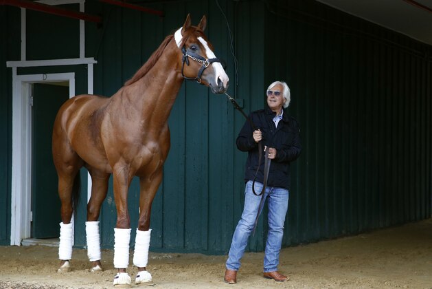 Trainer Bob Baffert walks Kentucky Derby winner Justify in a barn, Wednesday, May 16, 2018, after Justify's arrival at Pimlico Race Course in Baltimore. The Preakness Stakes horse race is scheduled to take place May 19. (AP Photo/Patrick Semansky)