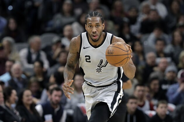 San Antonio Spurs forward Kawhi Leonard (2) moves the ball up court during the second half of an NBA basketball game against the Denver Nuggets, Saturday, Jan. 13, 2018, in San Antonio. San Antonio won 112-80. (AP Photo/Eric Gay)