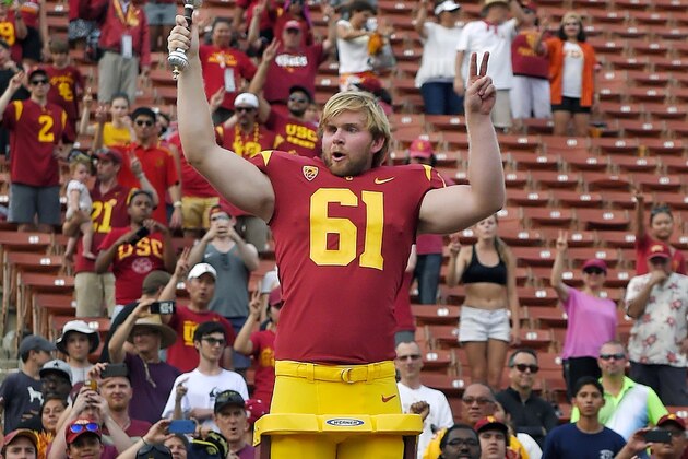 Southern California long snapper Jake Olson leads the USC Trojan Marching Band following an NCAA college football game against Western Michigan, Saturday, Sept. 2, 2017, in Los Angeles. Olson lost his sight eight years ago to a rare form of retinal cancer, but joined the USC team on a scholarship for disabled athletes and began practicing with the Trojans 2 years ago. (AP Photo/Mark J. Terrill)