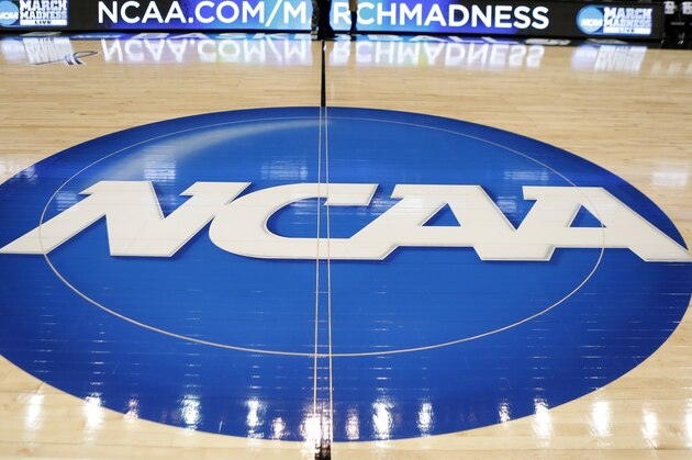 FILE - In this March 18, 2015, file photo, the NCAA logo is at center court as work continues at The Consol Energy Center in Pittsburgh, for the NCAA college basketball second and third round games. The NCAA is moving toward reforming transfer rules. There is much work to be done and any drastic changes are likely a few years away. New transfer rules will be rooted in academics, and could give higher achieving students more freedom while limiting who might be less likely to graduate if they switch schools.(AP Photo/Keith Srakocic, File)