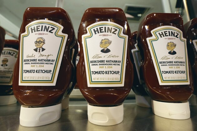 Heinz commemorative Ketchup bottles bear the cartoon likeness of investor Warren Buffett, right, and of his second in command Charlie Munger, left, at a Heinz display in Omaha, Neb., Friday, May 2, 2014,  one day before the Berkshire Hathaway annual shareholders meeting which takes place on Saturday. (AP Photo/Nati Harnik)
