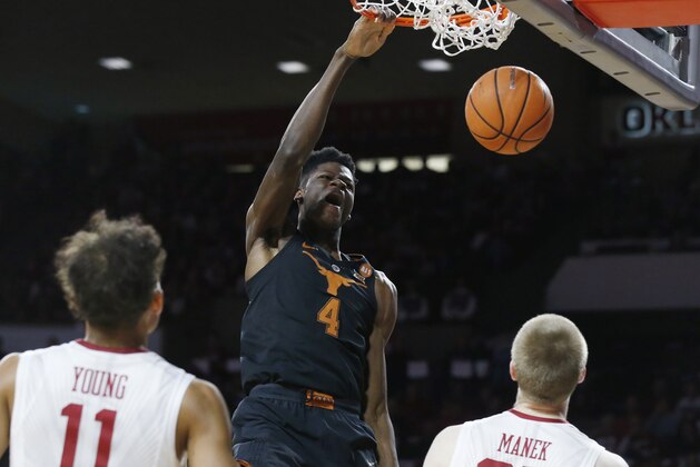 FILE - In this Feb. 17, 2018, file photo, Texas forward Mohamed Bamba (4) dunks in front of Oklahoma guard Trae Young (11) and forward Brady Manek (35) in the first half of an NCAA college basketball game, in Norman, Okla. Bamba was named to the AP All-Big 12 team, Tuesday, March 6, 2018. (AP Photo/Sue Ogrocki, File)
