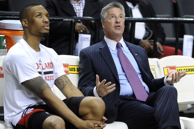Portland Trail Blazers' Damian Lillard, left, chats with Trail Blazers GM Neil Olshey prior to the start of an NBA basketball game in Portland, Ore., Saturday, March 28, 2015. (AP Photo/Greg Wahl-Stephens)