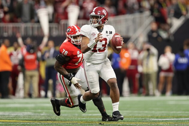 ATLANTA, GA - JANUARY 08:  Quarterback Tua Tagovailoa #13 of the Alabama Crimson Tide scrambles with the football ahead of defensive tackle Trenton Thompson #78 of the Georgia Bulldogs during the CFP National Championship presented by AT&T at Mercedes-Benz Stadium on January 8, 2018 in Atlanta, Georgia. The  Crimson Tide defeated the Bulldogs 26-23.  (Photo by Christian Petersen/Getty Images)