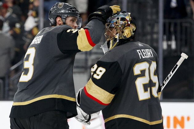 Vegas Golden Knights defenseman Brayden McNabb, left, celebrates with goaltender Marc-Andre Fleury after the team's 4-2 win against the Winnipeg Jets during Game 3 of the NHL hockey playoffs Western Conference finals Wednesday, May 16, 2018, in Las Vegas. (AP Photo/John Locher)