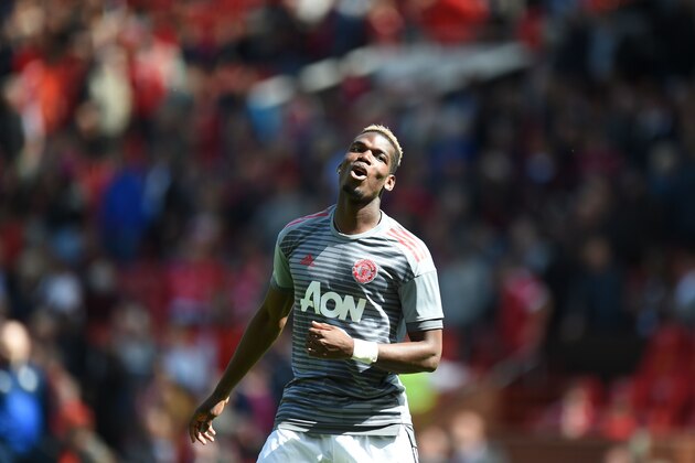 Manchester United's French midfielder Paul Pogba warms up for the English Premier League football match between Manchester United and Watford at Old Trafford in Manchester, north west England, on May 13, 2018. (Photo by Oli SCARFF / AFP) / RESTRICTED TO EDITORIAL USE. No use with unauthorized audio, video, data, fixture lists, club/league logos or 'live' services. Online in-match use limited to 75 images, no video emulation. No use in betting, games or single club/league/player publications. /         (Photo credit should read OLI SCARFF/AFP/Getty Images)