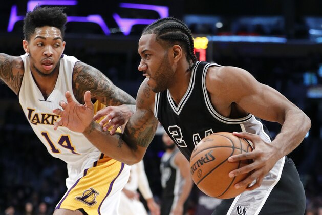 San Antonio Spurs' Kawhi Leonard, right, drives past Los Angeles Lakers' Brandon Ingram during the second half of an NBA basketball game, Sunday, Feb. 26, 2017, in Los Angeles. (AP Photo/Jae C. Hong)