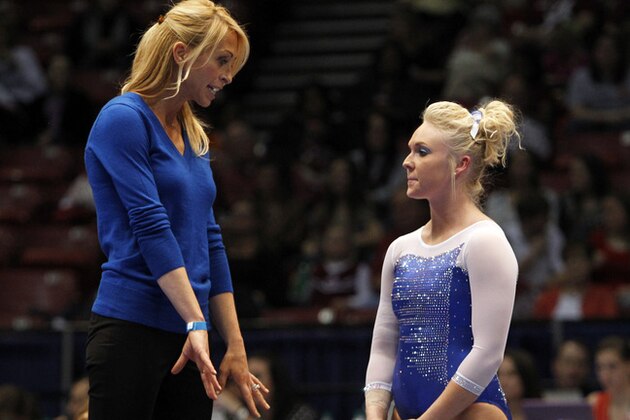 Florida coach Rhonda Faehn talks with Rachel Spicer during the NCAA women's gymnastics championships on Friday, April 18, 2014, in Birmingham, Ala. (AP Photo/Butch Dill)