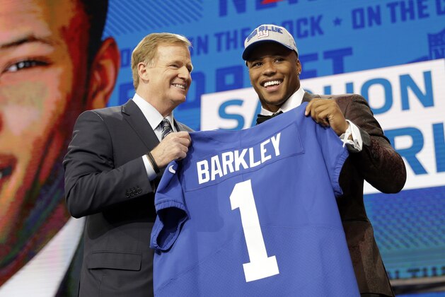 Commissioner Roger Goodell presents Penn State's Saquon Barkley with his New York Giants jersey during the first round of the NFL football draft, Thursday, April 26, 2018, in Arlington, Texas. (AP Photo/David J. Phillip)