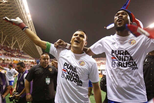 Costa Rica goalkeeper Keylor Navas, left, and teammate Kendall Waston celebrate after playing Honduras to a 1-1 draw, during a World Cup qualifying soccer match at the National Stadium in San Jose, Costa Rica, Saturday, Oct. 7, 2017. Waston scored in the fifth minute of second-half stoppage time, giving Costa Rica a 1-1 tie against visiting Honduras and clinching the Ticos' second straight World Cup berth and fifth overall. (AP Photo/Moises Castillo)