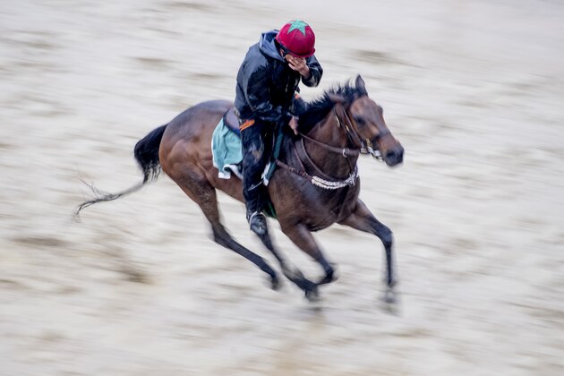 BALTIMORE, MD - MAY 17: An exercise rider clears water from his eyes as he gallops a horse during preparations for the Preakness at Pimlico Race Course on May 15, 2018 in Baltimore, Maryland (Photo by Scott Serio/Eclipse Sportswire/Getty Images)