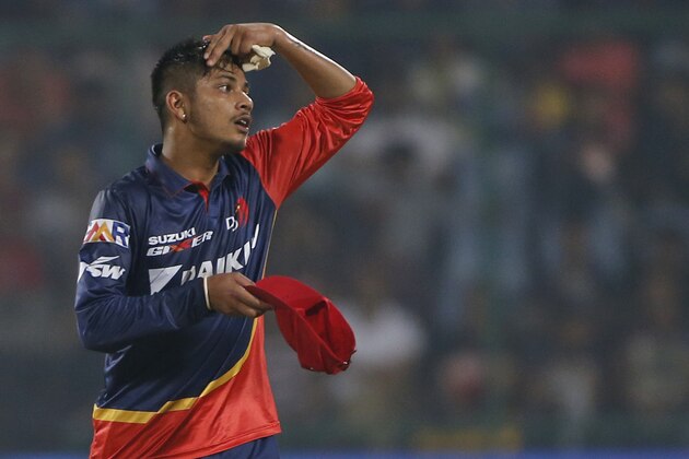 Delhi Daredevils' bowler Sandeep Lamichhane prepares to wear his cap after finishing his over in his debut match during VIVO IPL cricket T20 match against Royal Challengers Bangalore in New Delhi, India, Saturday, May 12, 2018. (AP Photo/Altaf Qadri)