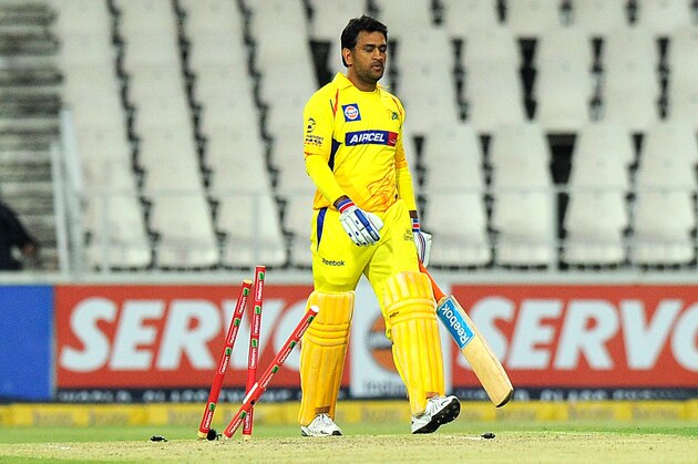 Chennai Super Kings batsman Mahendra Singh Dhoni walks with his bat during the Champions League T20 (CLT20) game between The Chennai Super Kings and the Mumbai Indians at the Wanderers Stadium in Johannesburg on October 20, 2012. AFP PHOTO / ALEXANDER JOE        (Photo credit should read ALEXANDER JOE/AFP/Getty Images)