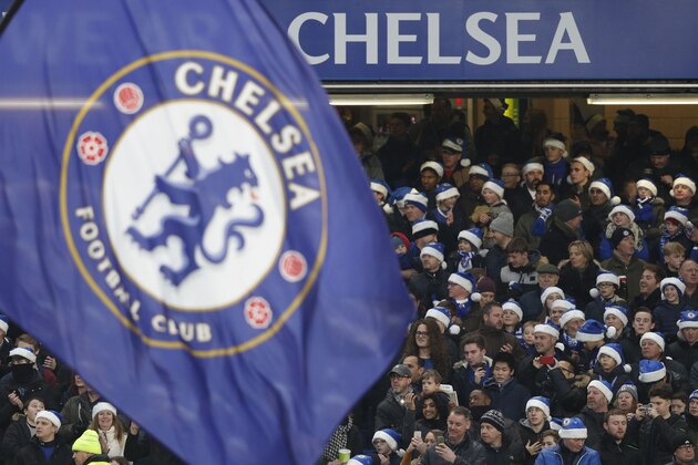 Chelsea fans wear blue santa hats during the English Premier League football match between Chelsea and Southampton at Stamford Bridge in London on December 16, 2017. / AFP PHOTO / Adrian DENNIS / RESTRICTED TO EDITORIAL USE. No use with unauthorized audio, video, data, fixture lists, club/league logos or 'live' services. Online in-match use limited to 75 images, no video emulation. No use in betting, games or single club/league/player publications.  /         (Photo credit should read ADRIAN DENNIS/AFP/Getty Images)