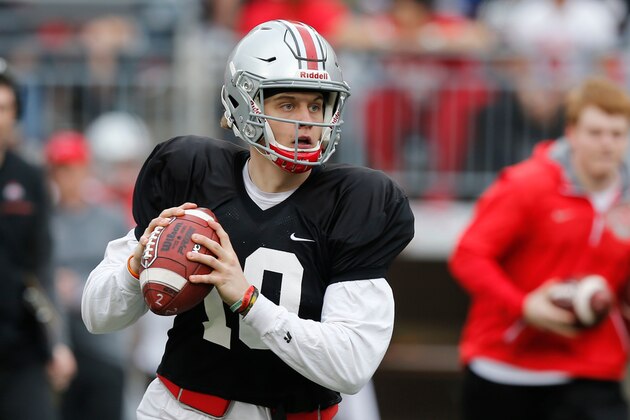 FILE - In this April 14, 2018, file photo, Ohio State quarterback Joe Burrow drops back to pass during an NCAA college spring football game in Columbus, Ohio. Facing the possibility of sitting as a backup for a third season at Ohio State, quarterback Joe Burrow announced on Tuesday, May 8, 2018,  his intention to transfer. The news from the redshirt junior, delivered via Twitter, wasn’t unexpected.  (AP Photo/Jay LaPrete, File)