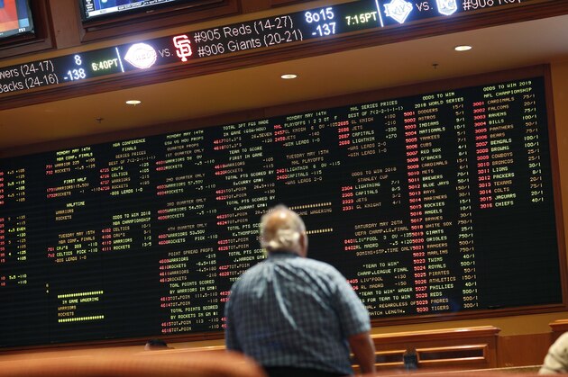 In this Monday, May 14, 2018 photo, betting odds are displayed on a board in the sports book at the South Point hotel and casino in Las Vegas. Now that the U.S. Supreme Court has cleared the way for states to legalize sports betting, the race is on to see who will referee the multi-billion-dollar business expected to emerge from the decision. (AP Photo/John Locher)