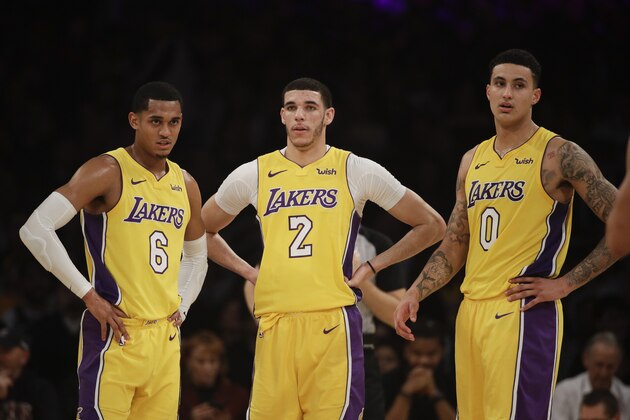 Los Angeles Lakers' Jordan Clarkson, from left, Lonzo Ball and Kyle Kuzma stand on the court during the first half of an NBA basketball game against the San Antonio Spurs Thursday, Jan. 11, 2018, in Los Angeles. (AP Photo/Jae C. Hong)