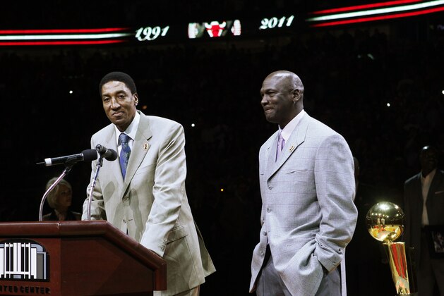 In this photo taken Saturday, March 12, 2011, former Chicago Bull Scottie Pippen, left, addresses the crowd with Michael Jordan, as teammates from their 1990-91 season celebrate the 20th anniversary of the Bulls' first NBA championship, during halftime of an NBA game against the Bulls and Utah Jazz   in Chicago. (AP Photo/Charles Rex Arbogast)
