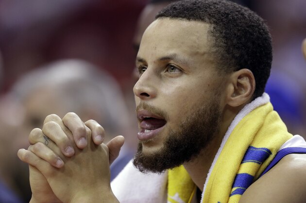 Golden State Warriors guard Stephen Curry sits on the bench during the final moments of the second half in Game 2 of the NBA basketball Western Conference Finals against the Houston Rockets, Wednesday, May 16, 2018, in Houston. (AP Photo/David J. Phillip)