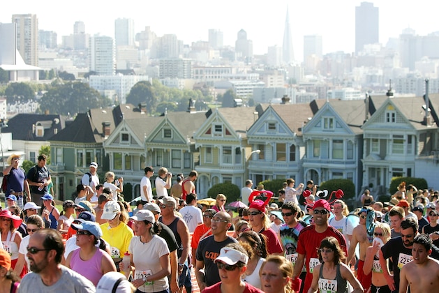 SAN FRANCISCO - MAY 17:  Participants run up Hayes Street Hill with the backdrop of the city's 'Painted Ladies' houses during the ING Bay to Breakers race May 17, 2009 in San Francisco, California.  Now in its 98th year, the ING Bay to Breakers 12K is one of the world's largest and oldest footraces, featuring world-class athletes in addition to costumed runners.  (Photo by Ezra Shaw/Getty Images)