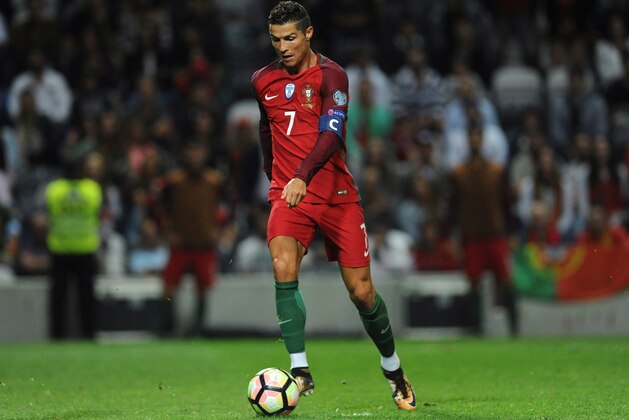 FILE - In this Thursday Aug. 31, 2017 file photo, Portugal's Cristiano Ronaldo scores his side's fourth goal during the World Cup Group B qualifying soccer match between Portugal and Faroe Islands at the Bessa Stadium in Porto, Portugal. (AP Photo/Paulo Duarte, File)
