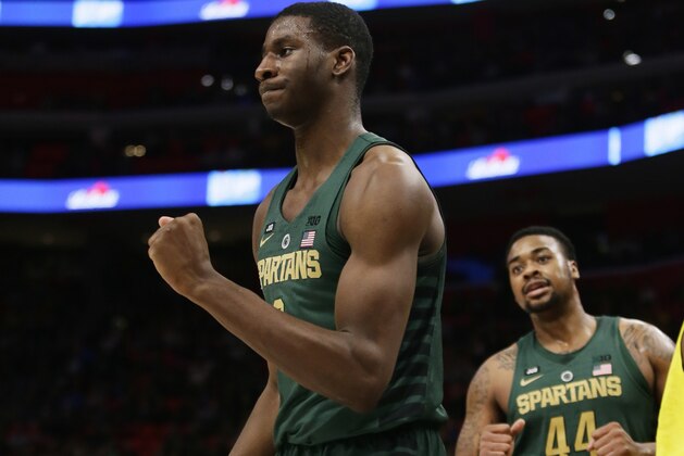 Michigan State forward Jaren Jackson Jr., left, pumps his fist after being fouled and making the shot as teammate Nick Ward (44) looks on during the second half of an NCAA college basketball game against the Oakland Saturday, Dec. 16, 2017, in Detroit. (AP Photo/Duane Burleson)
