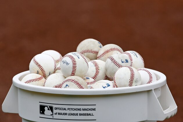 A bucket of baseballs awaits infield drills for the Cleveland Indians players at the team's baseball spring training facility Sunday, Feb. 19, 2017, in Goodyear, Ariz. (AP Photo/Ross D. Franklin)