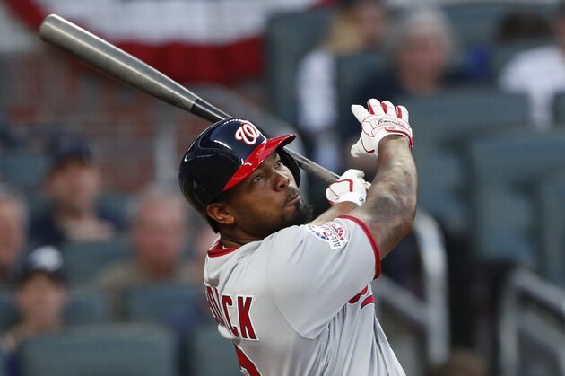 Washington Nationals left fielder Howie Kendrick (12) drives in a run with a double in the first inning of a baseball game against the Atlanta Braves Monday, April 2, 2018, in Atlanta. (AP Photo/John Bazemore)